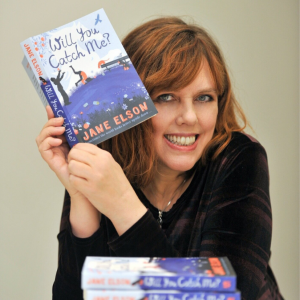 Image of Jane Elson (a middle-aged white woman with auburn hair) holding one of her middle grade novels, Will You Catch Me?